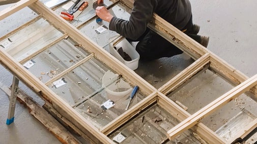 Specialist carpenter working on a window frame restoration